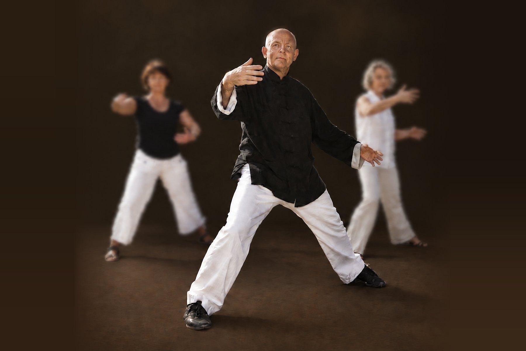 Horst-Rainer Rust übt mit zwei Kursteilnehmerinnen eine Qi-Gong-Bewegung